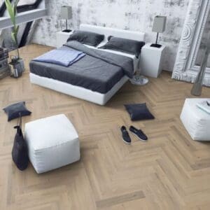 Contemporary bedroom with white bed and greige oak herringbone laminate flooring