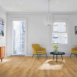 Natural oak laminate flooring in bright living room with yellow accent chairs