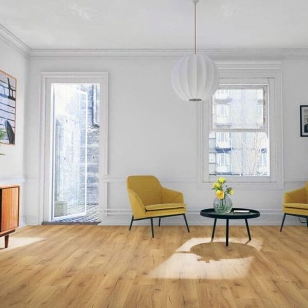 Natural oak laminate flooring in bright living room with yellow accent chairs