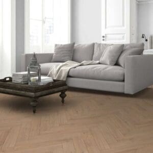 Lignum fusion premium oregon oak herringbone flooring installed in modern living room with grey sofa