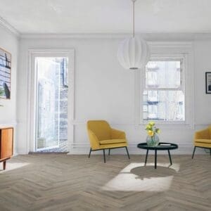 Bright living room with yellow chairs and volcanic oak herringbone flooring