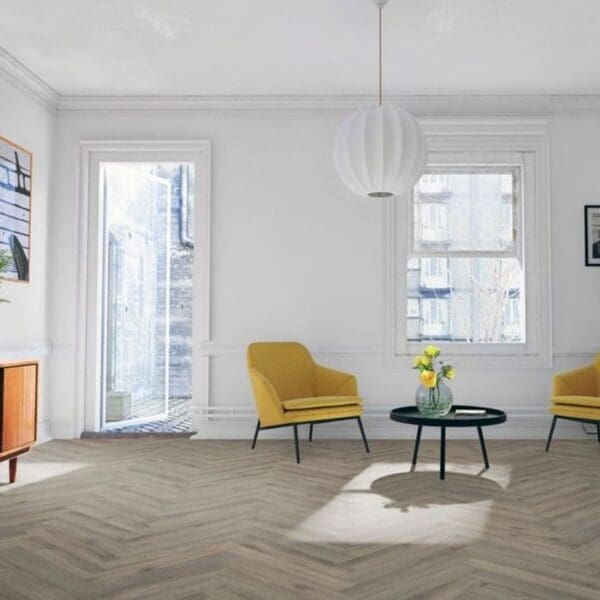 Bright living room with yellow chairs and volcanic oak herringbone flooring