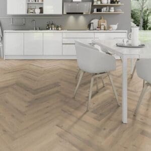 All white kitchen with dining area and greige oak herringbone laminate flooring