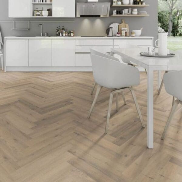 All white kitchen with dining area and greige oak herringbone laminate flooring