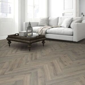 Cozy living room with fireplace and volcanic oak herringbone flooring