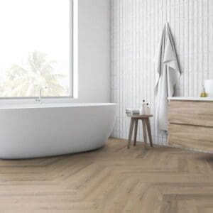 Contemporary bathroom with freestanding bath and greige oak herringbone laminate flooring