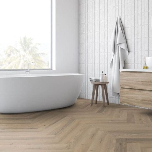 Contemporary bathroom with freestanding bath and greige oak herringbone laminate flooring