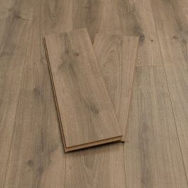 Pebble grey plank wood effect laminate flooring sample showing natural grain pattern