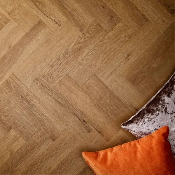 Textures traditional oak herringbone flooring with brown and orange decorative cushions