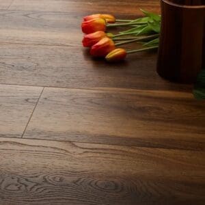 Textures warm walnut plank flooring with orange tulips and wooden container