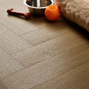Textures country oak herringbone flooring installed in pet-friendly space with dog bowl and toys