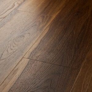 Close up view of textures warm walnut plank showing beveled edges and grain detail