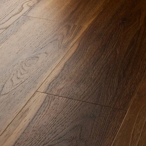 Close up view of textures warm walnut plank showing beveled edges and grain detail