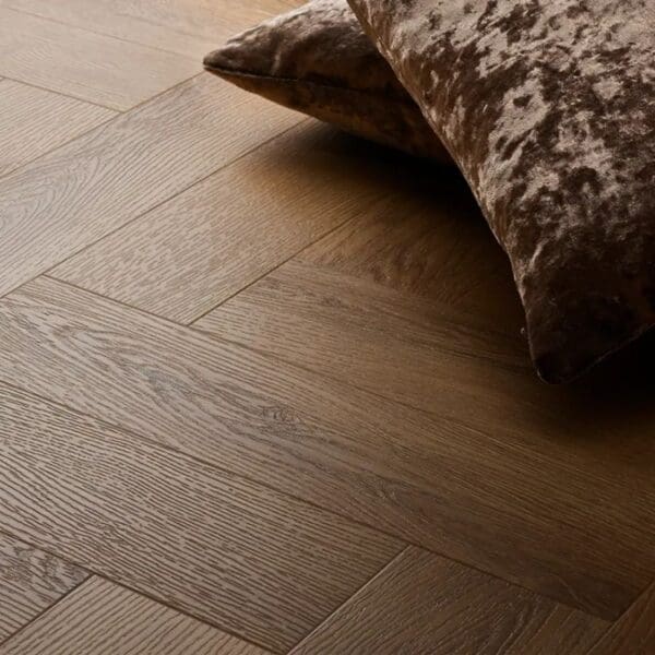 Textures traditional oak herringbone flooring with brown velvet cushion