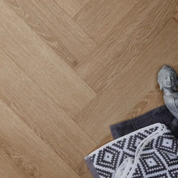 Textures light oak herringbone flooring with buddha statue and patterned rug