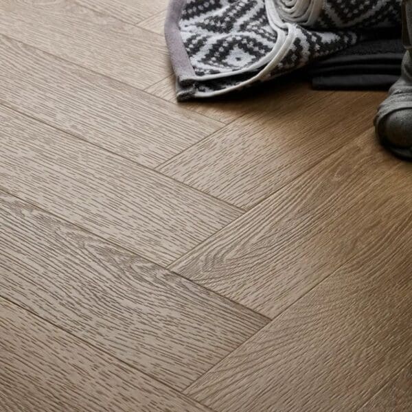 Textures light oak herringbone flooring with patterned rug and shoes