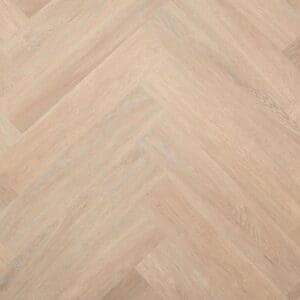 Overhead view of Blenheim Oak Herringbone SPC flooring showing the honey blonde wood effect pattern