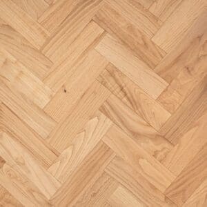 Natural oak engineered wood flooring in a herringbone parquet pattern with a smooth lacquered finish.