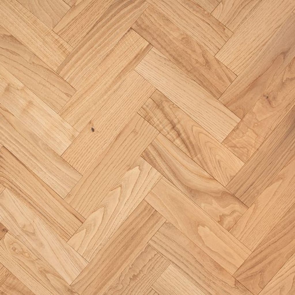 Natural oak engineered wood flooring in a herringbone parquet pattern with a smooth lacquered finish.
