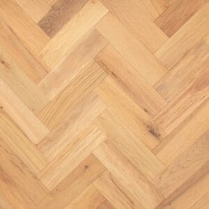 A top down view of Calveley Oak Herringbone engineered wood flooring showing the natural grain and brushed texture.