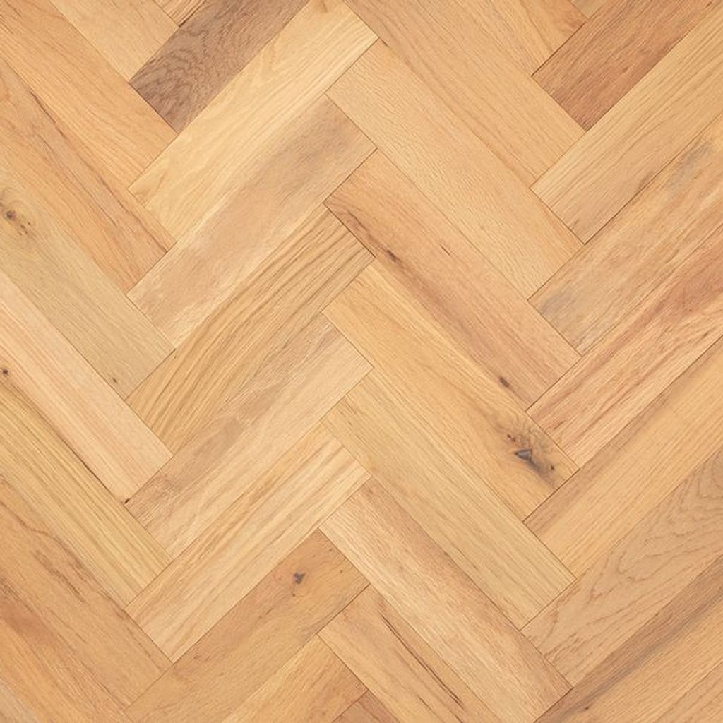 A top down view of Calveley Oak Herringbone engineered wood flooring showing the natural grain and brushed texture.