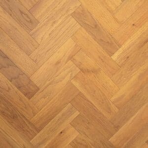Golden brushed and oiled oak engineered wood flooring in a herringbone parquet pattern