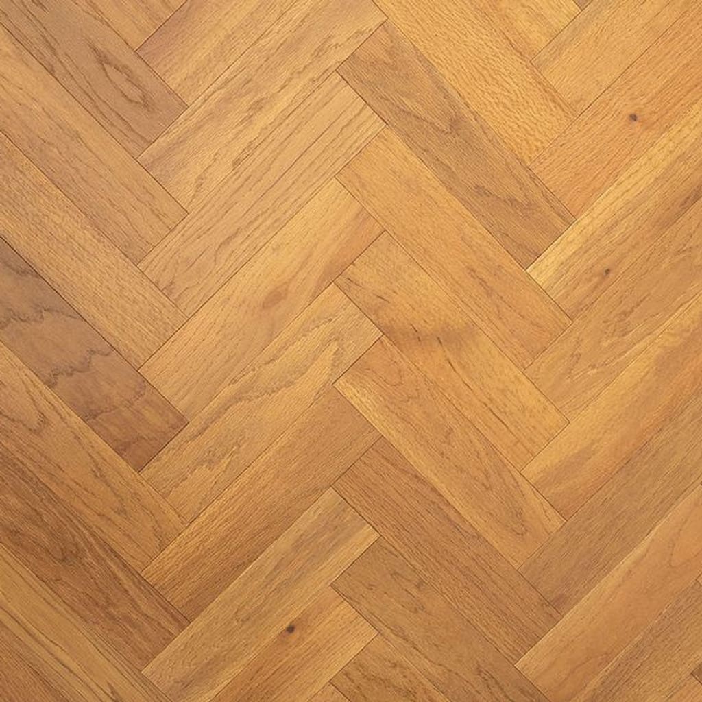 Golden brushed and oiled oak engineered wood flooring in a herringbone parquet pattern