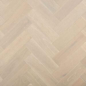 A top-down view of Dunham Oak Herringbone engineered wood flooring showing the grey brushed oak texture in a parquet pattern.