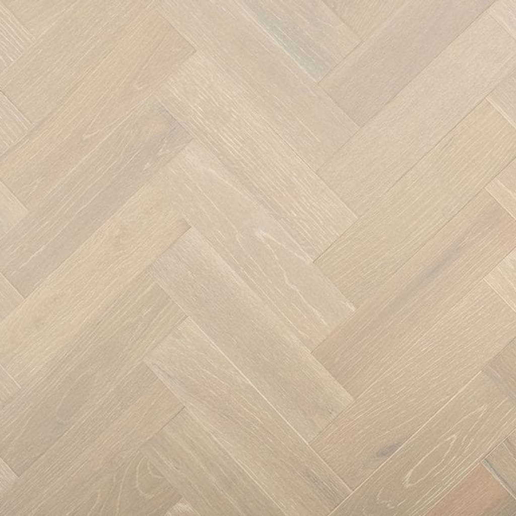 A top-down view of Dunham Oak Herringbone engineered wood flooring showing the grey brushed oak texture in a parquet pattern.