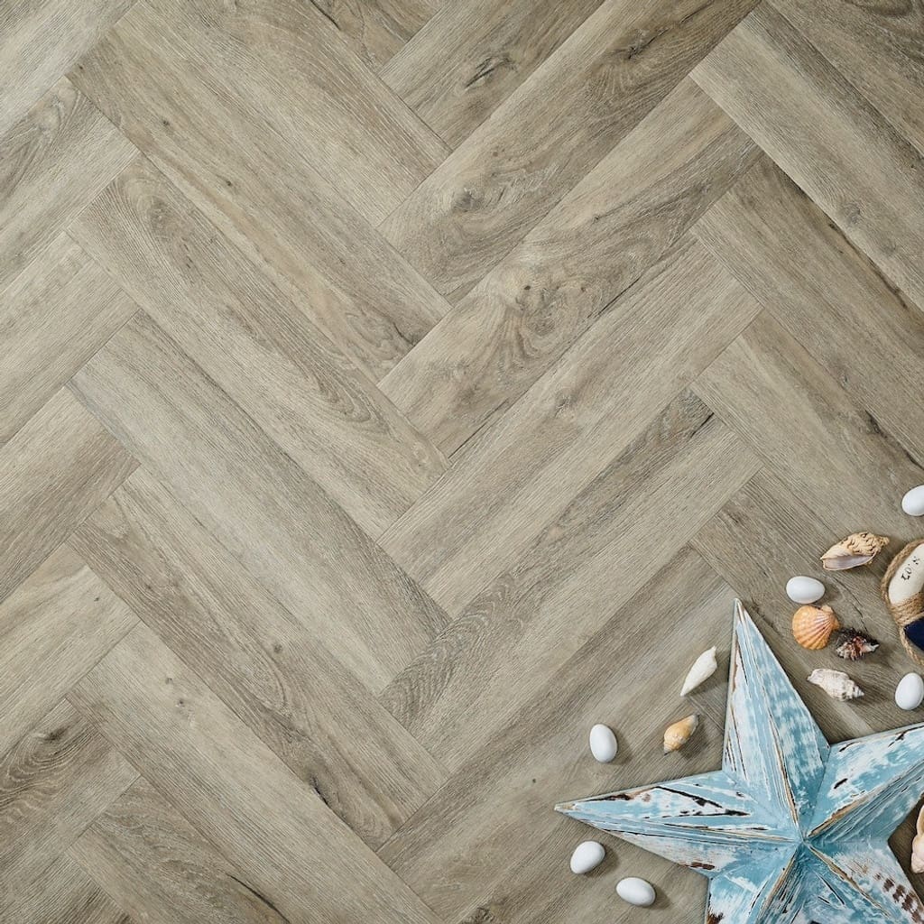 Elements Inspirations Dove Oak Herringbone EIH04 luxury vinyl flooring with beach-themed decorations.