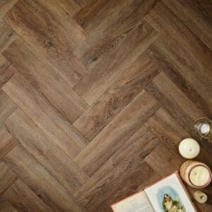 Elements Inspirations Espresso Herringbone EIH02 luxury vinyl flooring with book and candles
