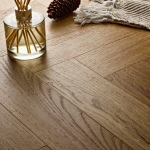 Elements Inspirations Golden Oak Herringbone EIH12 luxury vinyl flooring close-up showing herringbone pattern.