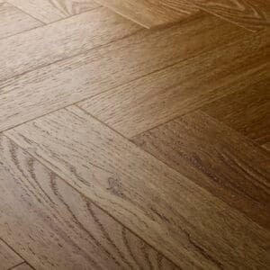 Elements Inspirations Golden Oak Herringbone EIH12 luxury vinyl flooring close-up showing the herringbone pattern.