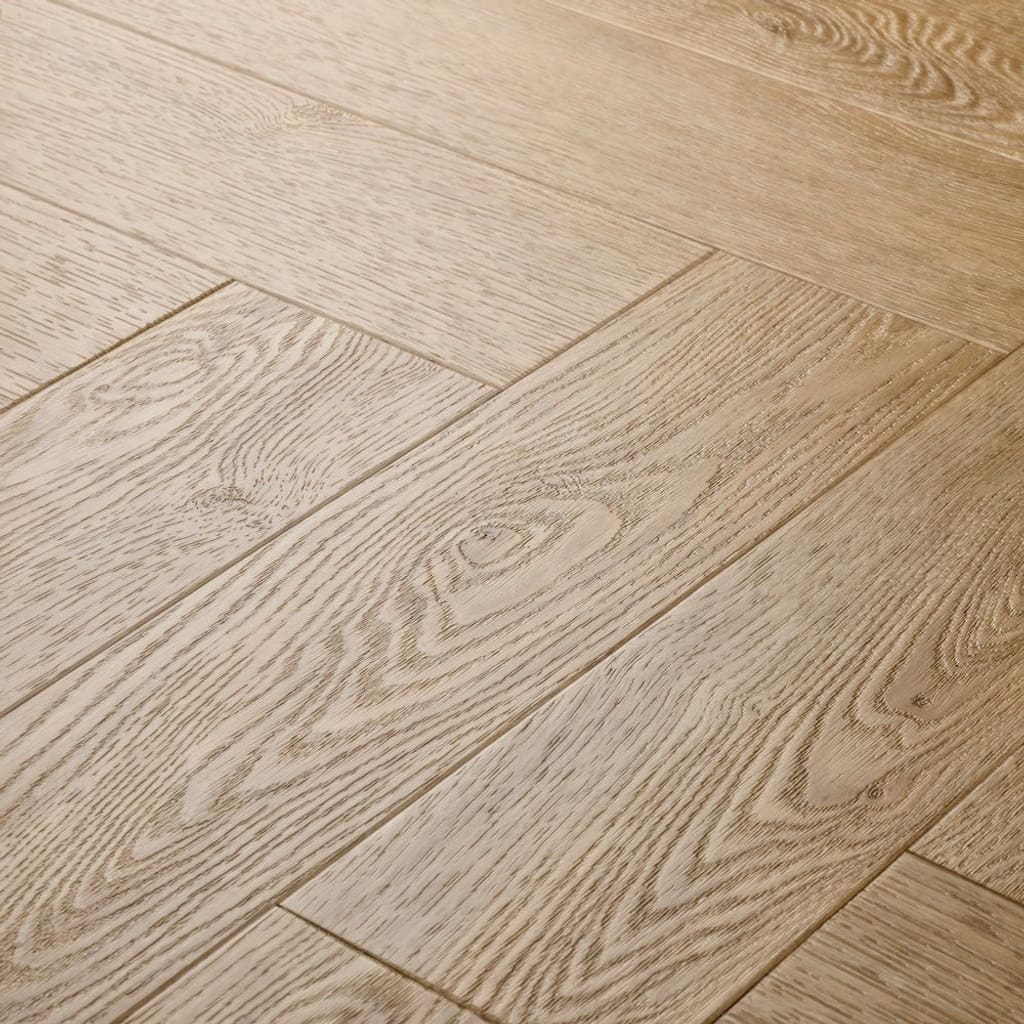 Close-up of Elements Inspirations Holm Oak Herringbone EIH10 luxury vinyl flooring showing wood grain detail.