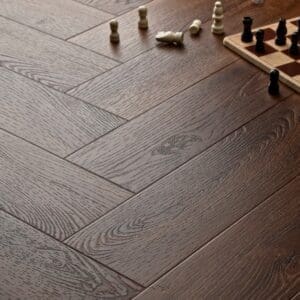 Elements Inspirations Mahogony Herringbone EIH06 luxury vinyl flooring with chess pieces on the floor.