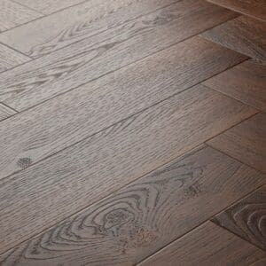 Elements Inspirations Mahogony Herringbone EIH06 luxury vinyl flooring close-up showing the wood grain and herringbone pattern.