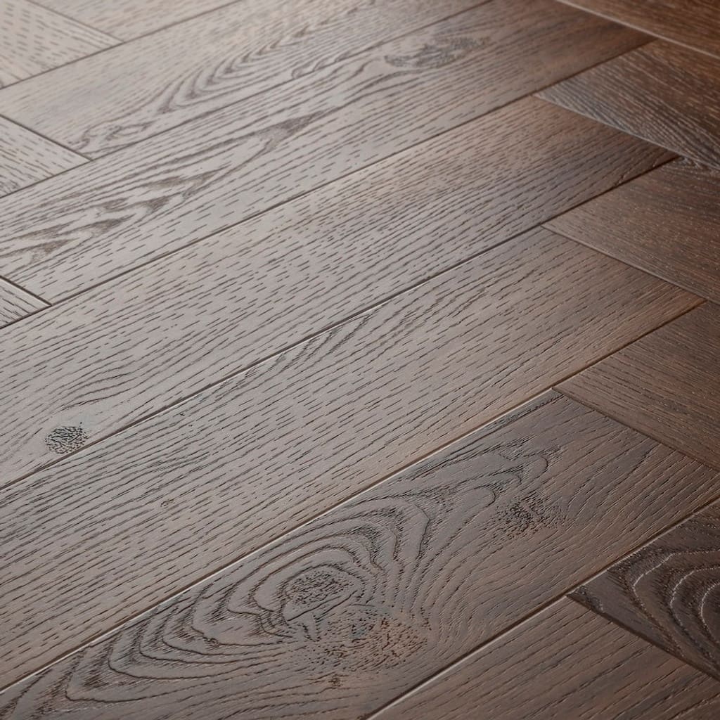 Elements Inspirations Mahogony Herringbone EIH06 luxury vinyl flooring close-up showing the wood grain and herringbone pattern.