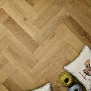 Elements Inspirations Natural Oak Herringbone EIH05 flooring detail with herringbone pattern and cushions.