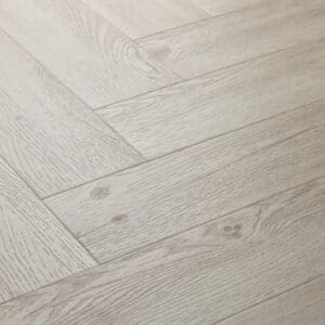 Elements Inspirations White Ash Herringbone EIH11 luxury vinyl flooring close-up showing the herringbone pattern.