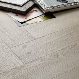 Elements Inspirations White Ash Herringbone EIH11 luxury vinyl flooring detail showing wood grain texture.