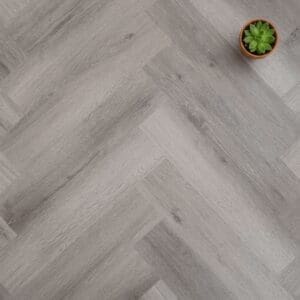 Kingham Oak Herringbone luxury vinyl flooring close-up texture - photorealistic room shot