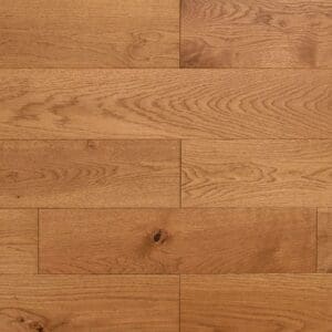 A close up view of Malpas Oak engineered wood planks showing the brushed texture and golden oiled finish