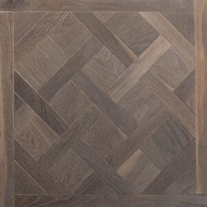 Grey brushed and oiled oak Versailles panel engineered wood flooring sample.