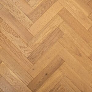 Golden brushed lacquered oak herringbone engineered wood flooring in a geometric parquet pattern