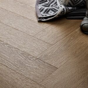 Textures Light Oak Herringbone TH10 vinyl flooring close-up showing wood grain detail