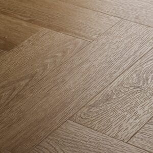Close up of Textures Light Oak Herringbone TH10 luxury vinyl flooring showing wood grain detail.