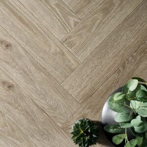 Textures LVT Ash Herringbone TH08 luxury vinyl flooring in a herringbone pattern with plants