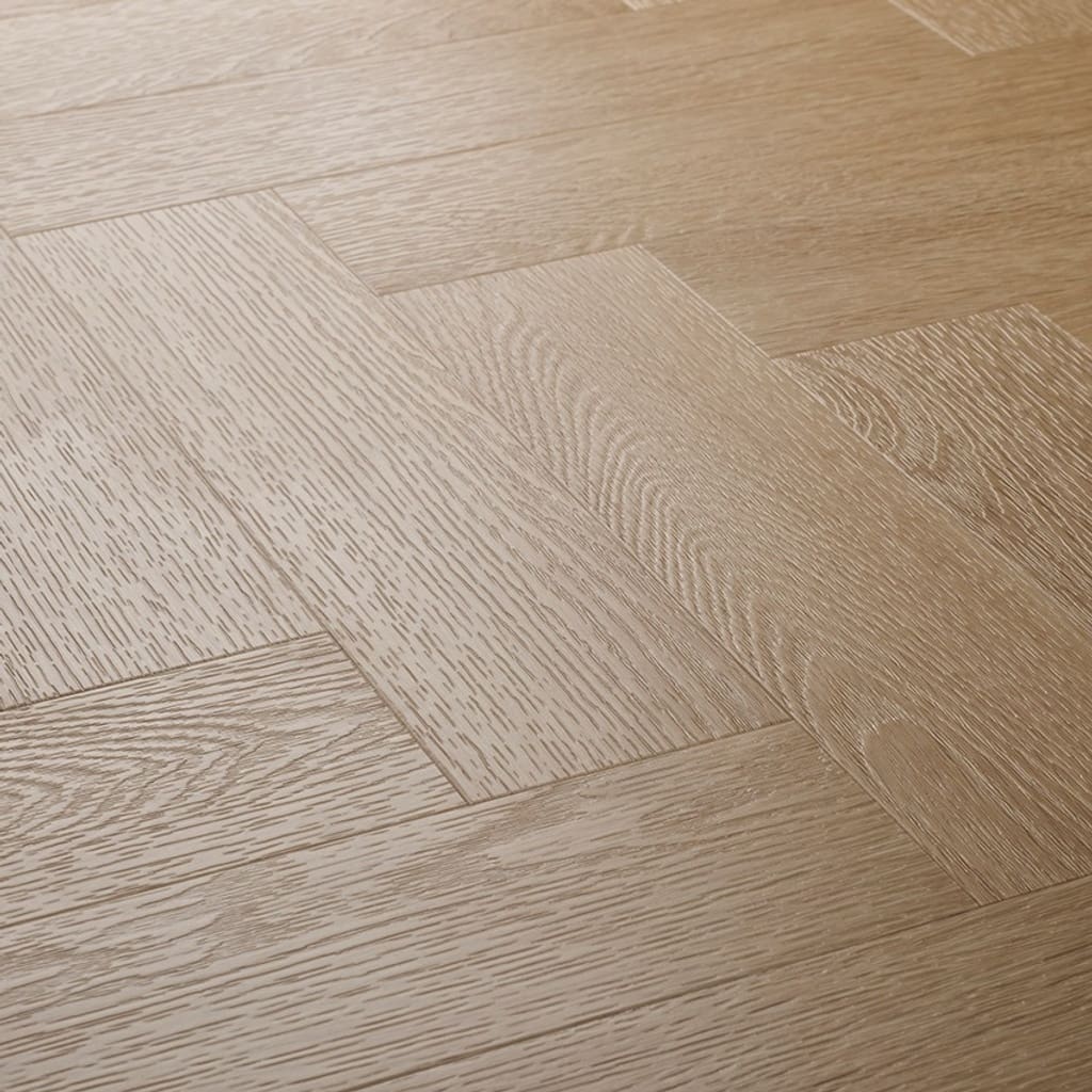 Close up of Textures LVT Blonde Oak Herringbone TH09 luxury vinyl flooring showing the herringbone pattern.