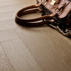 Textures LVT Blonde Oak Herringbone TH09 flooring detail with a handbag on the floor.