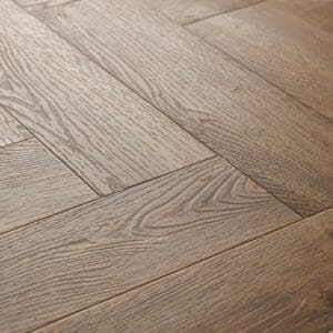 Textures LVT Distressed Oak Herringbone TH06 flooring close-up showing the wood grain texture.